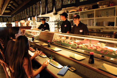 Customers at a sushi bar