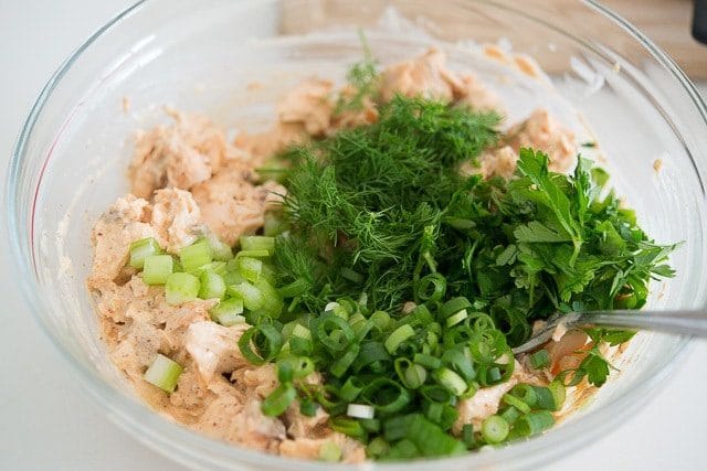 Green onion, dill, parsley, and celery Added to Salmon Salad Recipe In Bowl