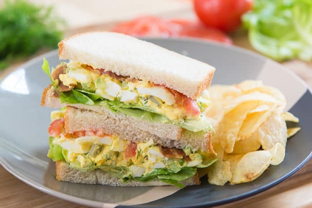 Egg Salad - Stuffed Into Sandwiches With Tomato and Lettuce and Served with Chips